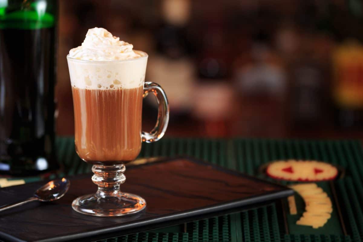 An Irish coffee glass with chocolate chip and whip cream