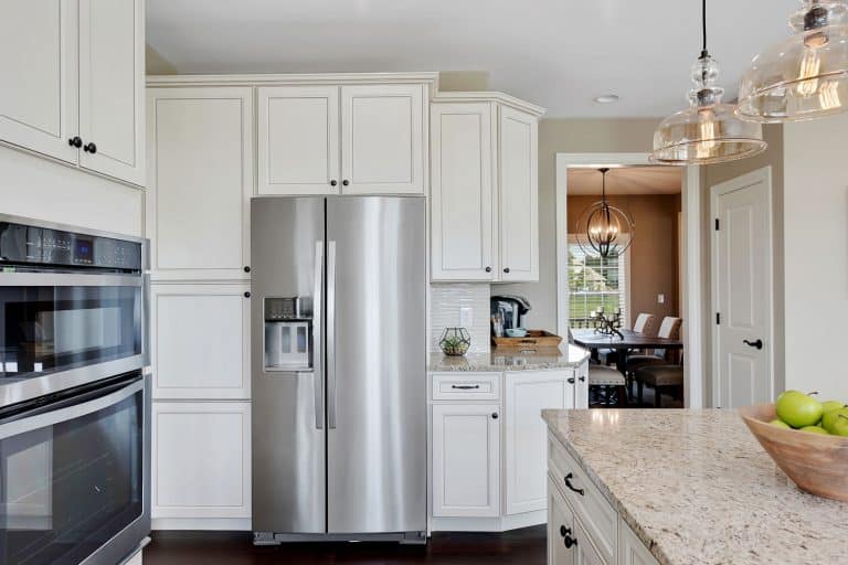 Classic century inspired kitchen with white cupboards and cabinets and a marble countertop, Can You Reset A Refrigerator By Unplugging It?