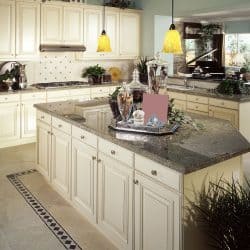 Elegant classic inspired kitchen with cream painted cupboards and cabinets with a brown granite countertop, What Color Walls Go With Brown Granite Countertops?