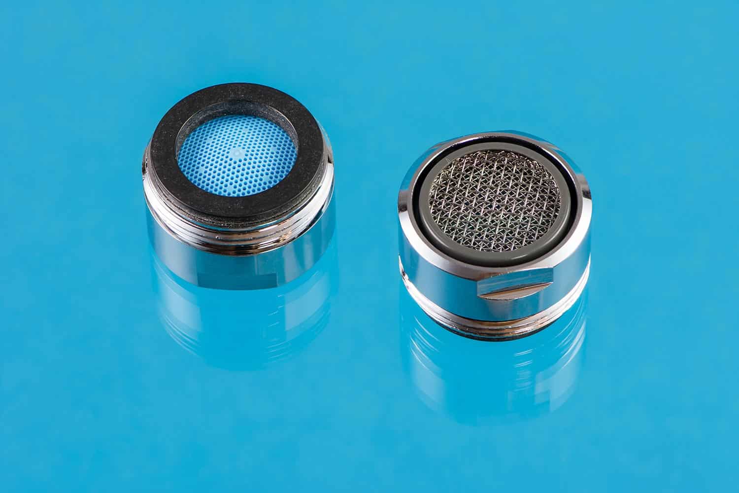 Macro of two faucet aerators for reducing water consumption