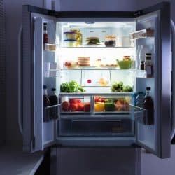 Open refrigerator full of juice and fresh vegetables, Which Way Should A Refrigerator Door Open?