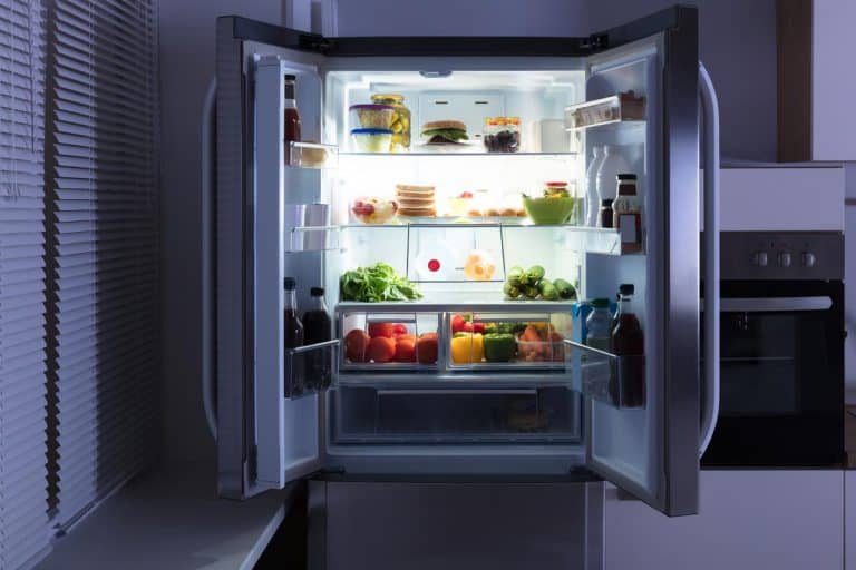 Open refrigerator full of juice and fresh vegetables, Which Way Should A Refrigerator Door Open?