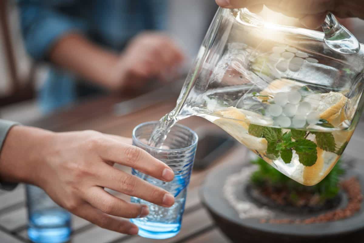 Pouring a glass or refreshing ice mint water