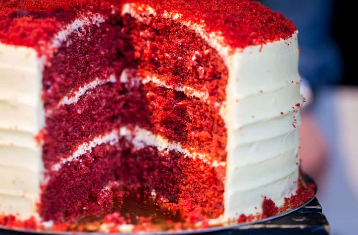 a freshly baked and iced red velvet sponge cake on display