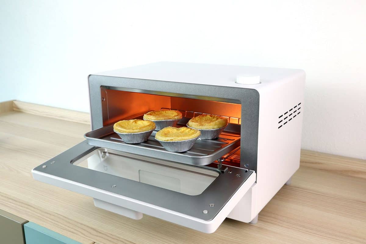 homemade egg tarts are in the white modern design toaster oven