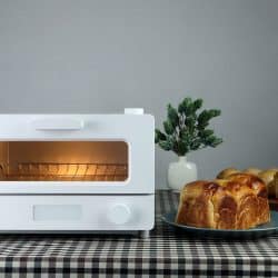 white modern design toaster oven is on the table with homemade sweet potato butter toast breads on grey cement wall background in the kitchen room for breakfast, How To Clean Cuisinart Toaster Oven