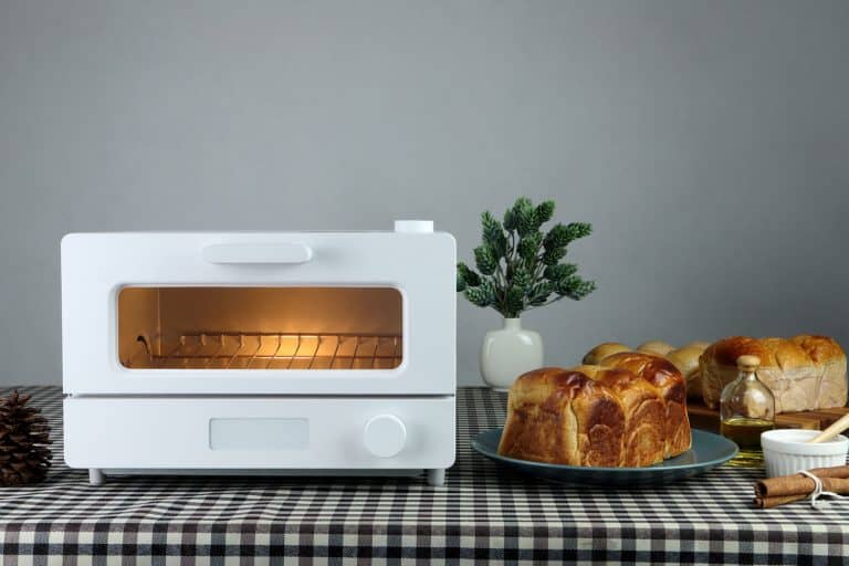 white modern design toaster oven is on the table with homemade sweet potato butter toast breads on grey cement wall background in the kitchen room for breakfast, How To Clean Cuisinart Toaster Oven