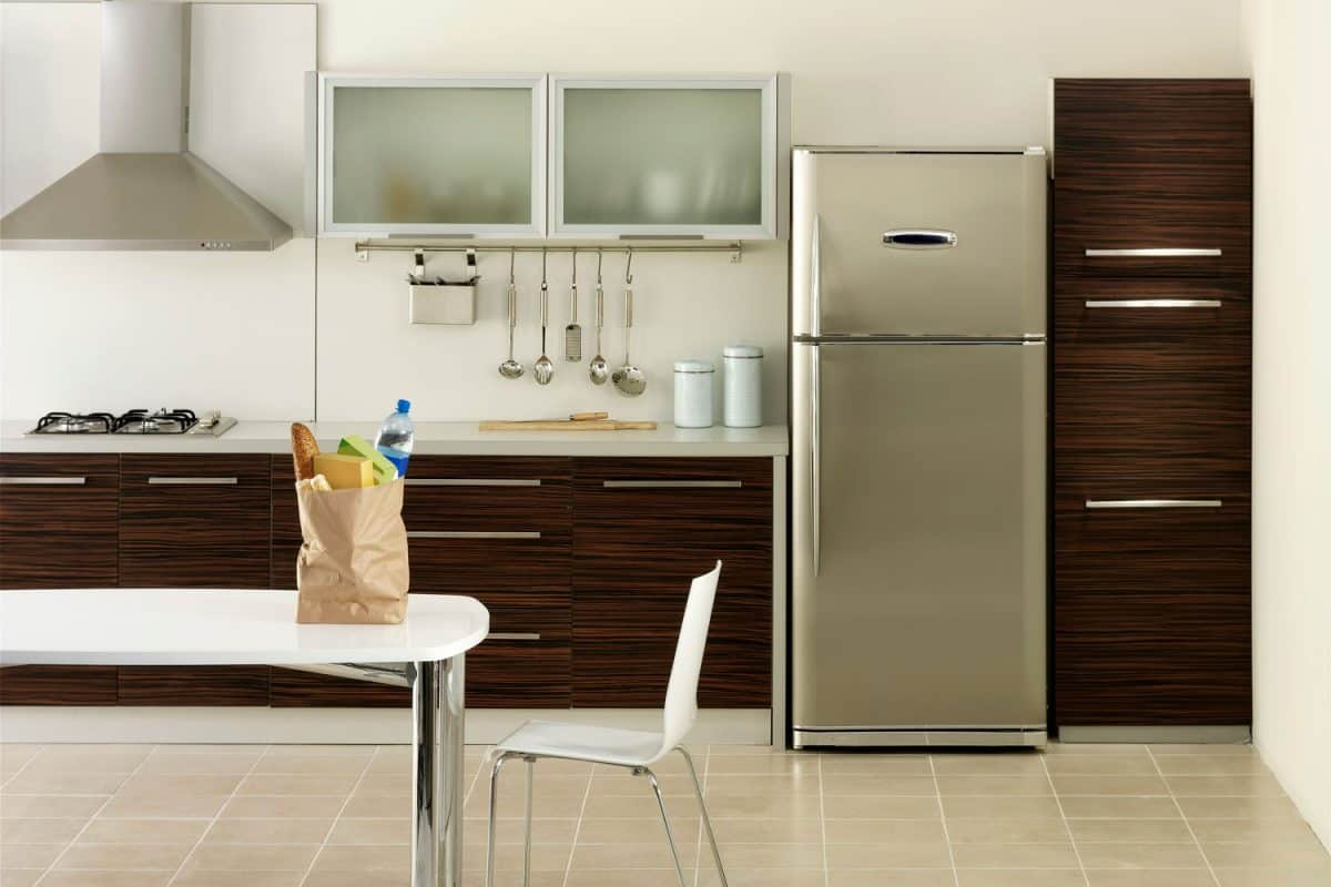 A refrigerator with aluminum wooden cabinets