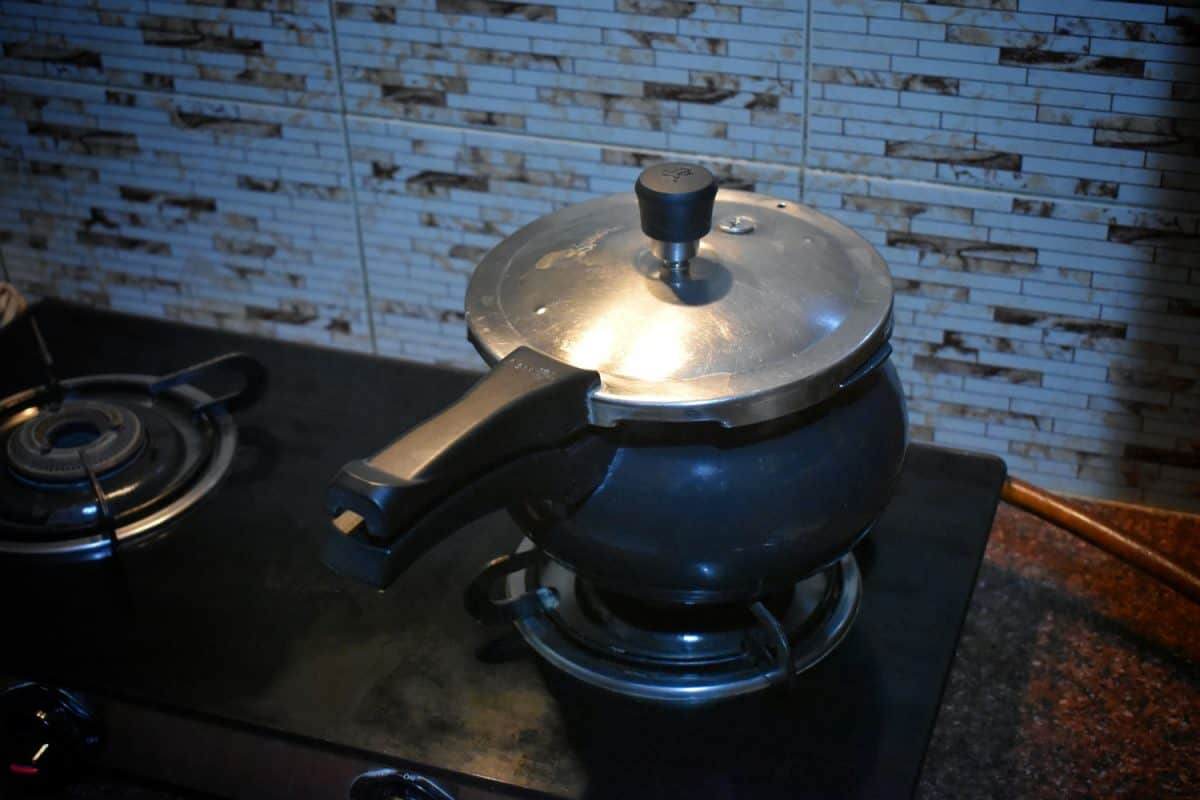 A round blue colored pressure cooker