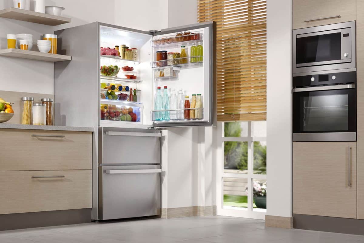 An opened refrigerator in the kitchen 