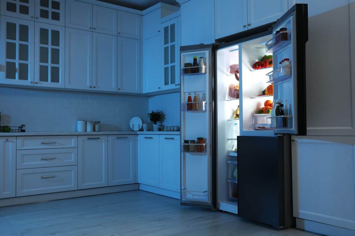 An opened refrigerator at night