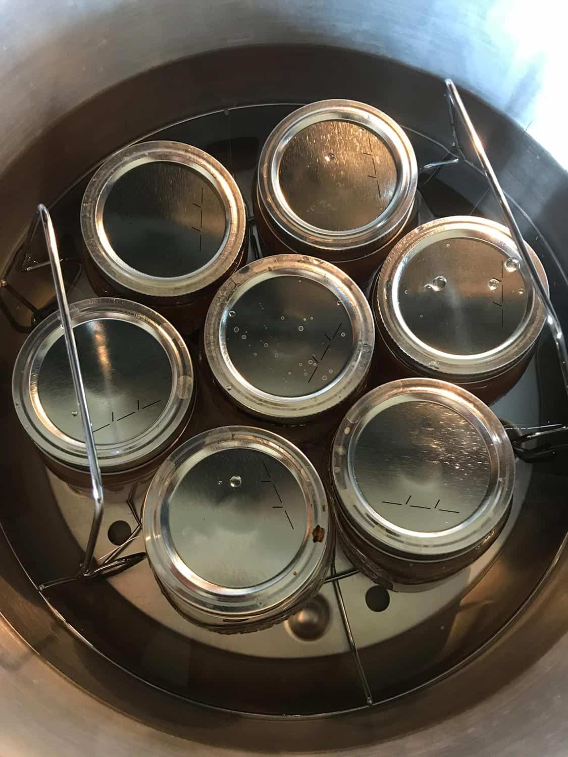 Canning jars in stainless steel pressure cooker water bath