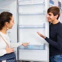 Customers choosing new large fridges in domestic appliances section in store, How Long Before You Can Use A New Refrigerator?