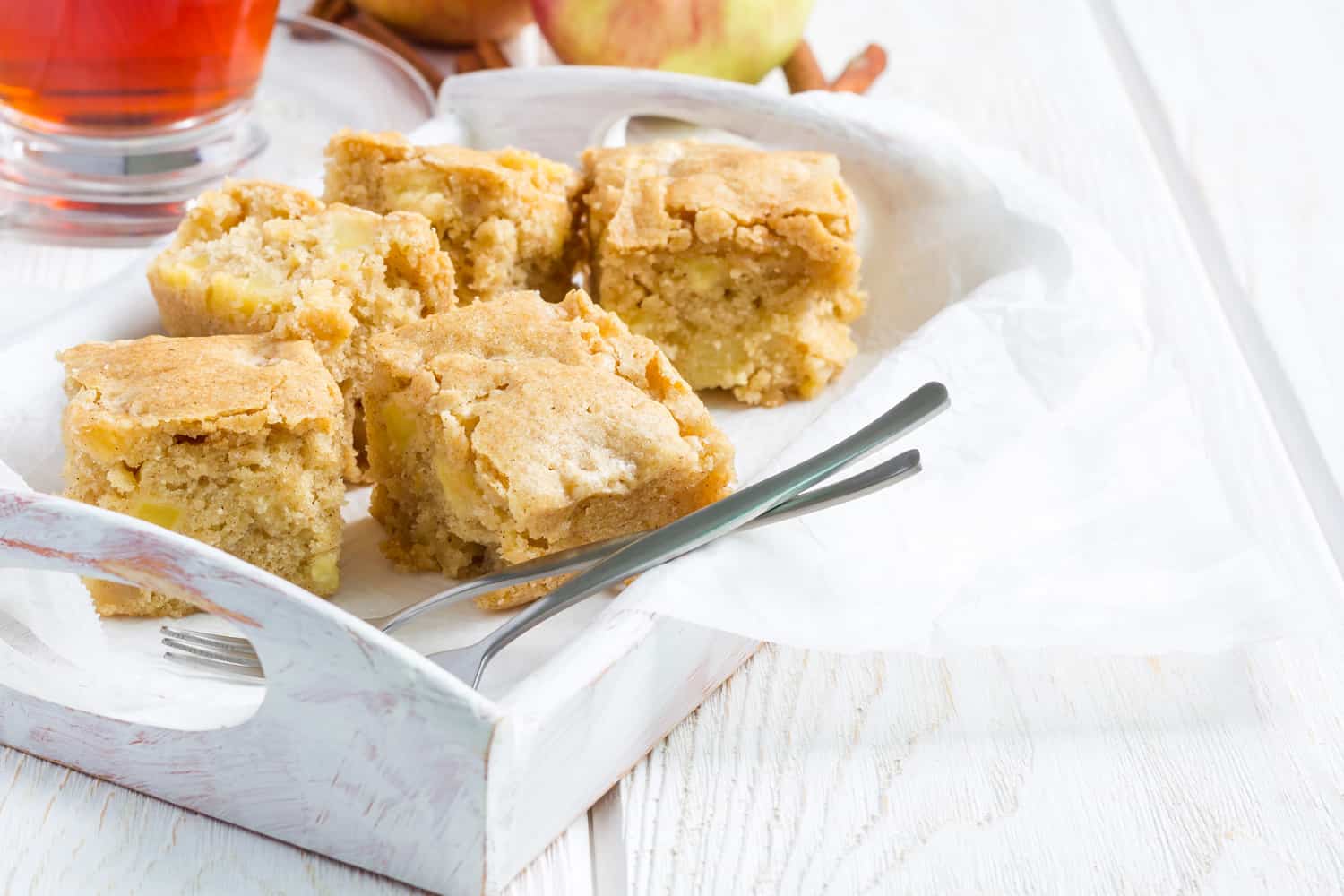Homemade blondie (blonde) brownies apple cake, square slices in wooden tray, horizonta