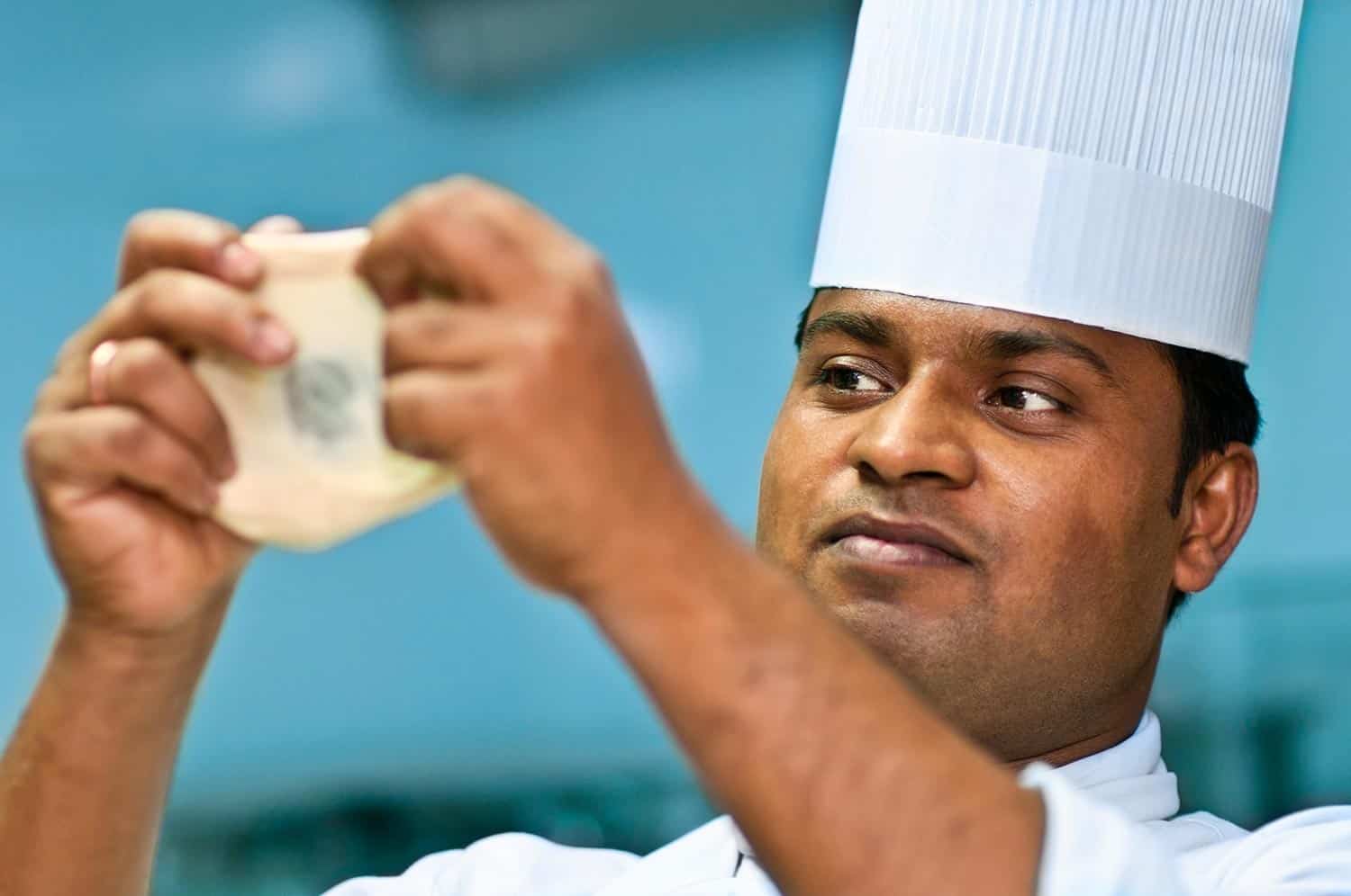 Indian chef checking the quality of dough