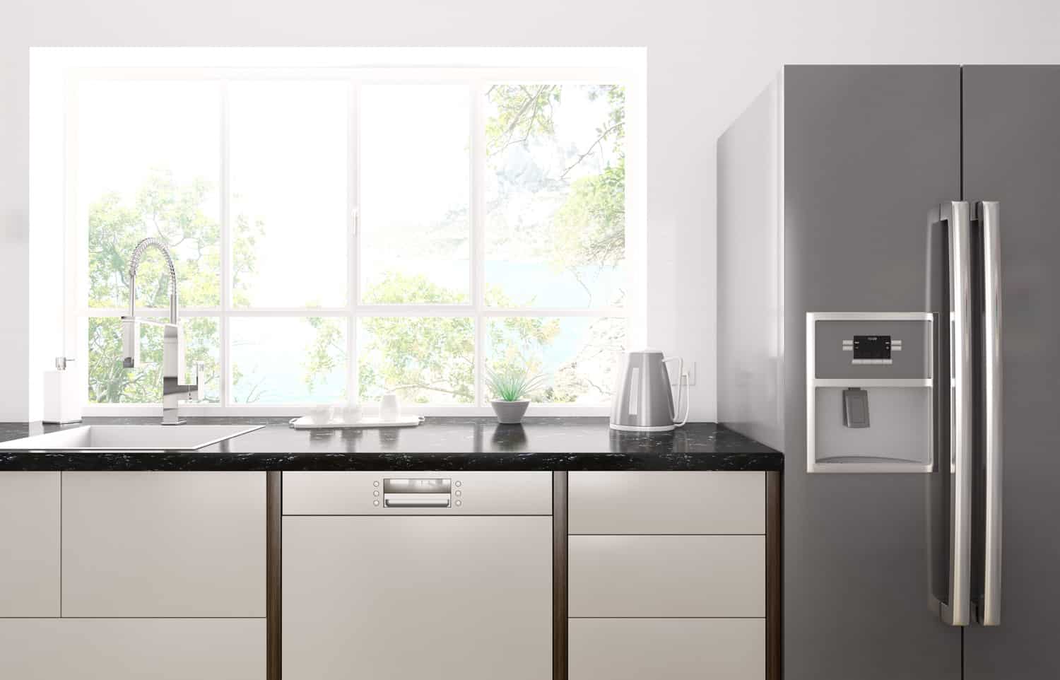 Interior of modern kitchen with black granite counter, refrigerator