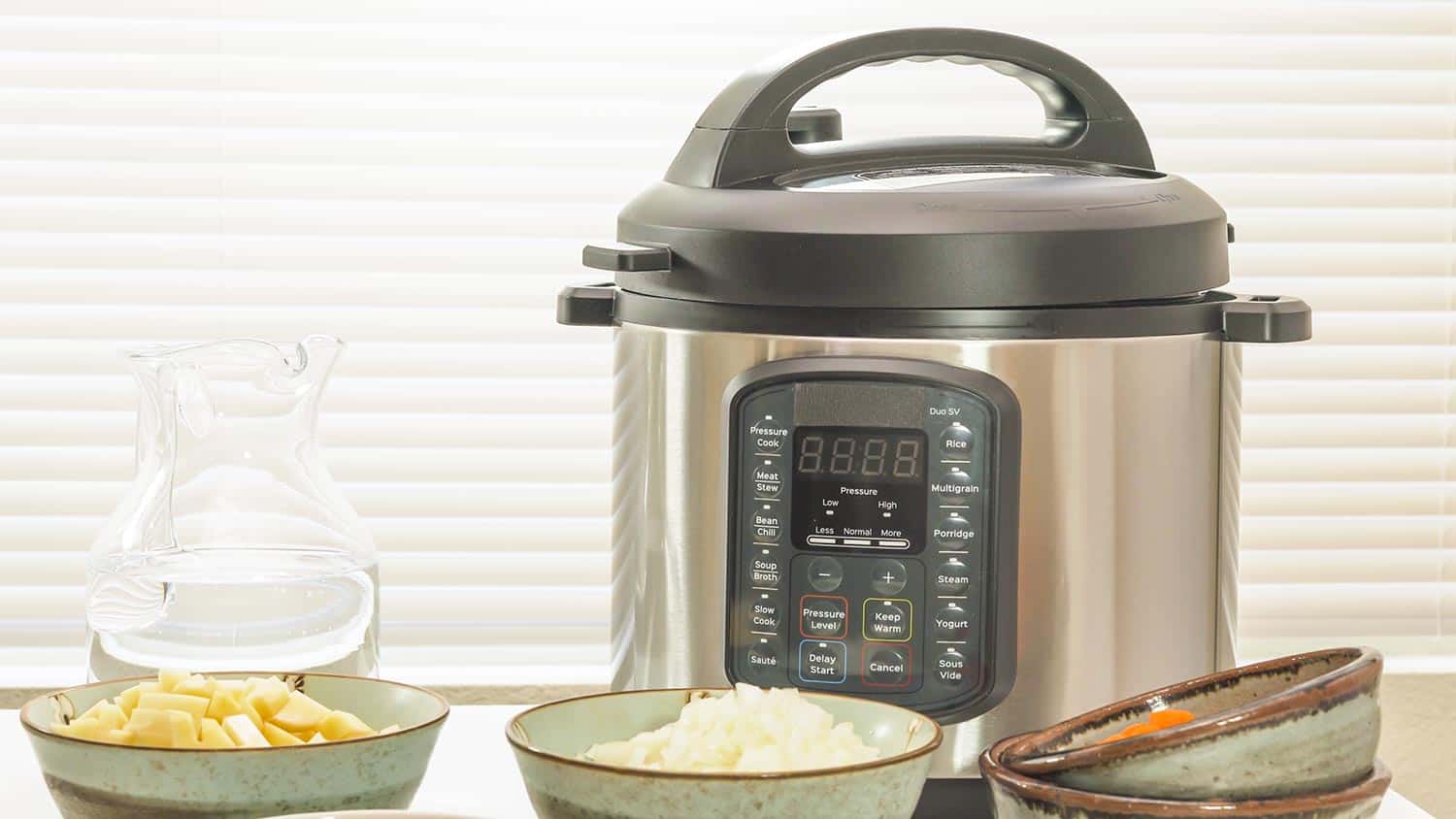 Modern electric multi cooker with some ingredients for cooking