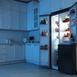Open refrigerator filled with food in kitchen at night - Can You Use Any Light Bulb In A Fridge?