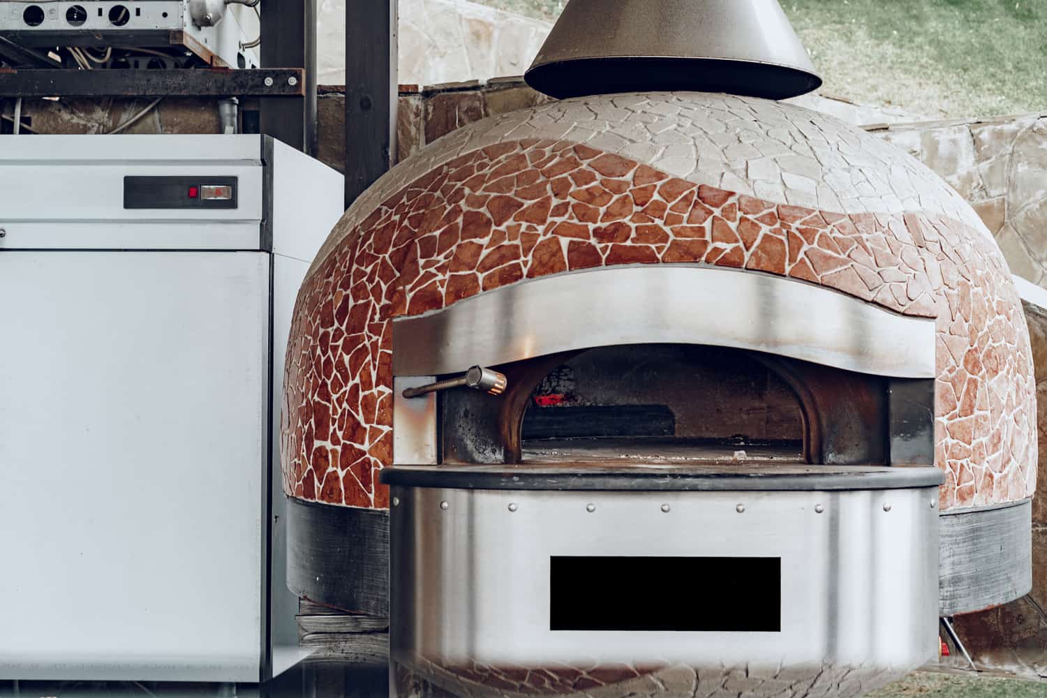 Outdoor pizza oven with mosaic decoratiion in a restaurant