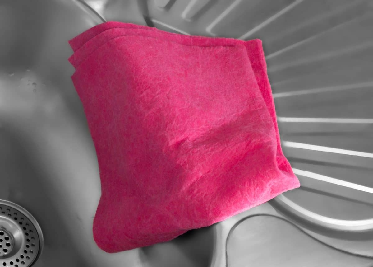Pink dish cloth on a sink.