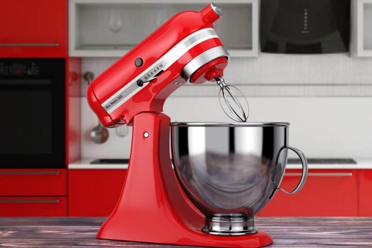 A red kitchen stand food mixer on a wooden table, How Much Does A Cuisinart Mixer Weigh?