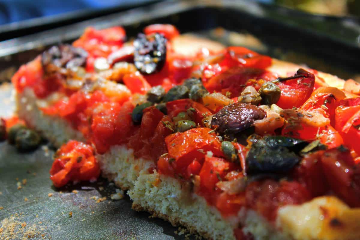 Vegetarian pizza made in Sicily with fresh tomatoes and ancient grains