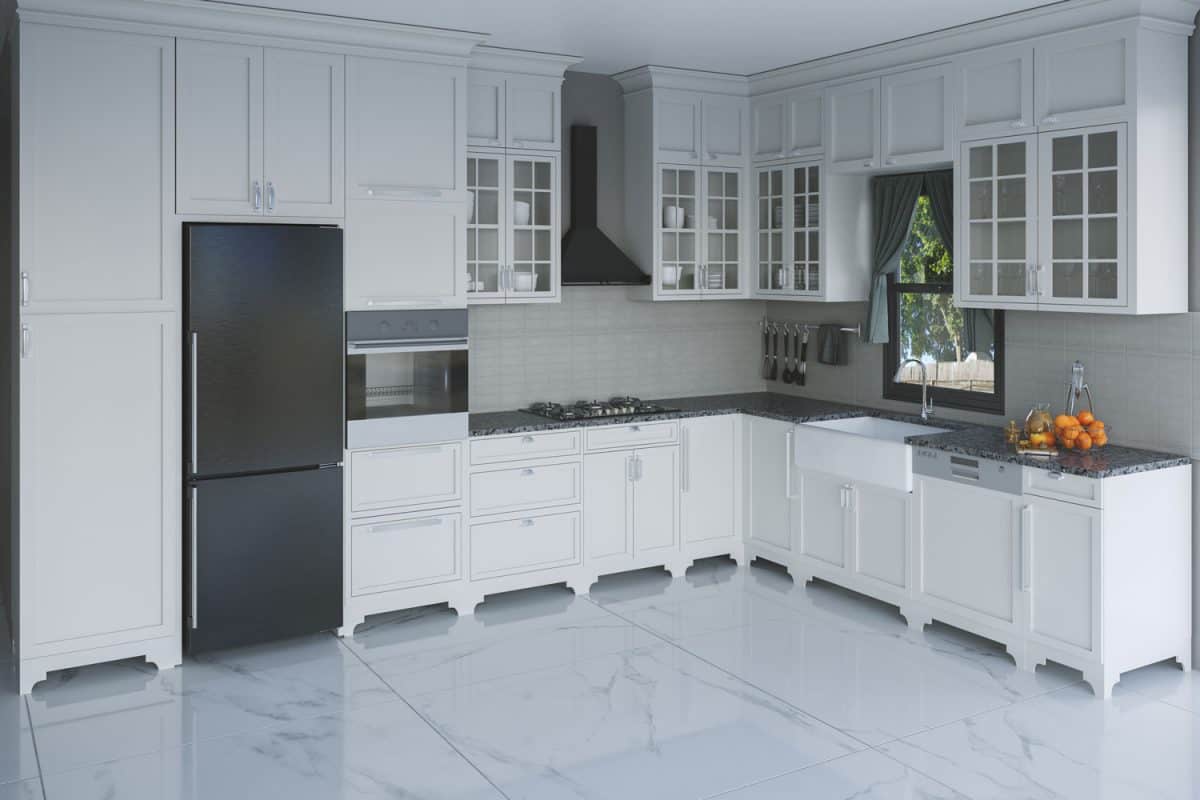 White cabinets and cupboards inside a large spacious kitchen