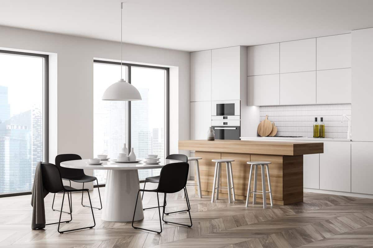 White kitchen room interior with black chairs and eating table