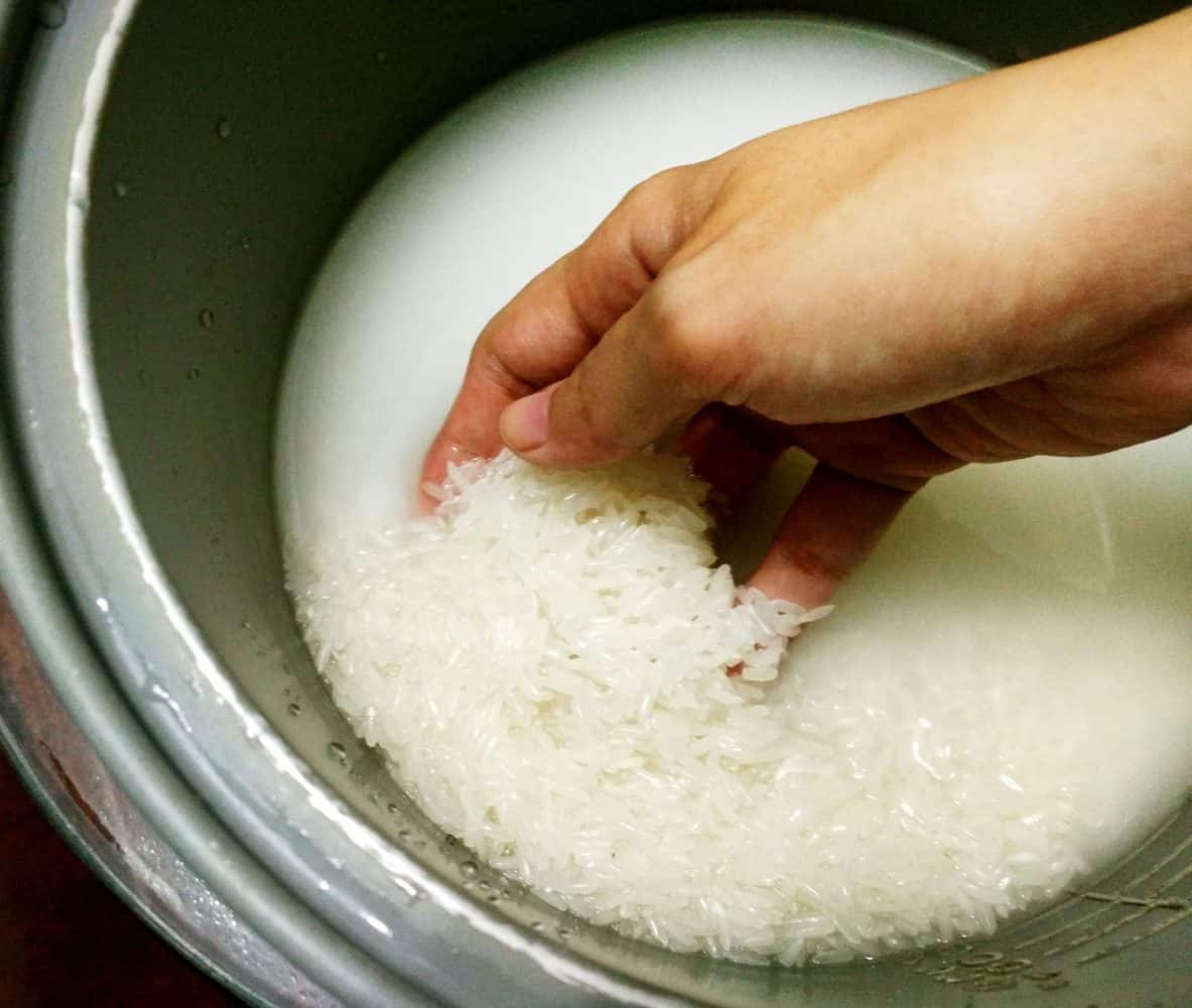 washing jasmine rice in a rice pot
