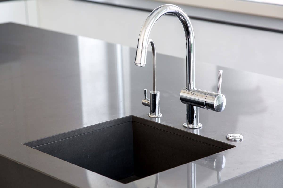 A chrome finished faucet in the kitchen breakfast bar