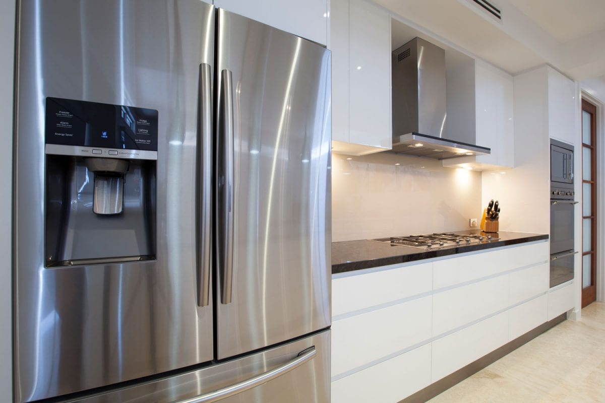 A huge and expensive looking refrigerator in a luxurious kitchen