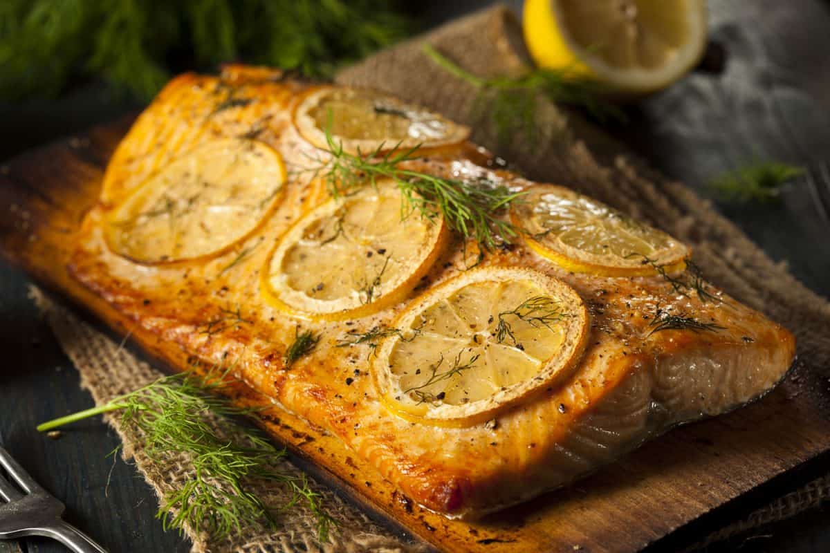 A huge slice of baked salmon with lemon, thyme and oregano