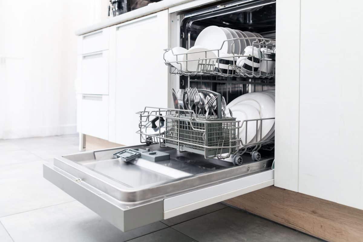 An opened dishwasher inside a modern kitchen 
