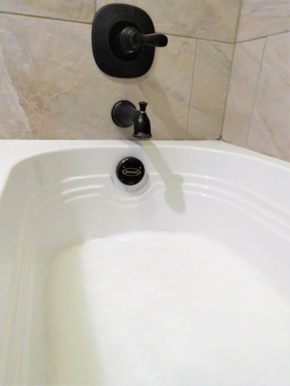 Bathtub with White Soap Bubbles