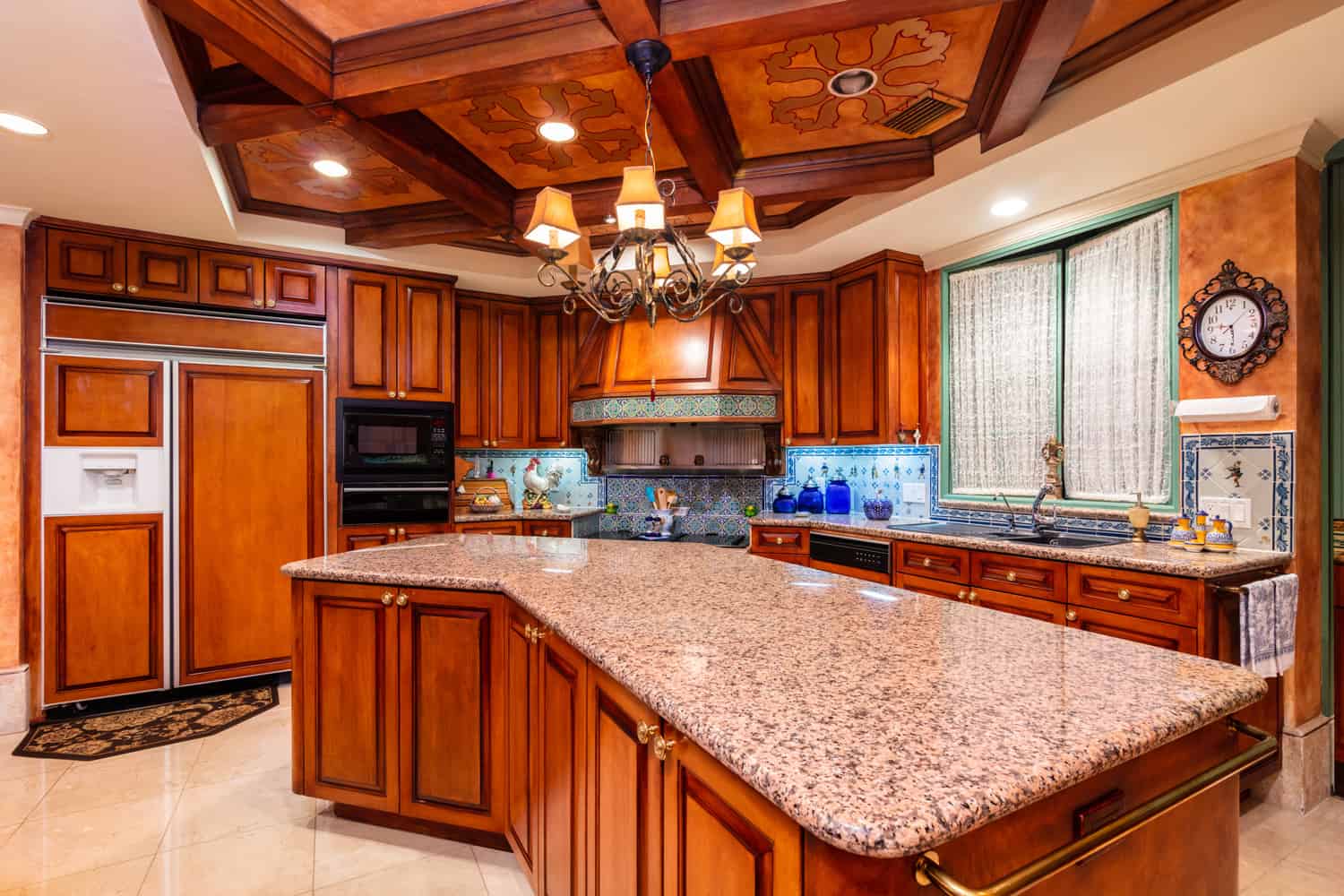 Beautiful luxury home kitchen with red cherry wood cabinets.