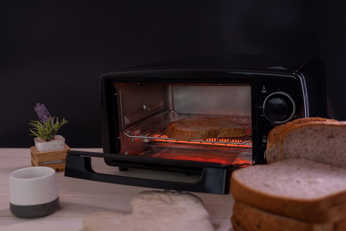 Black micro electric oven with whole wheat bread