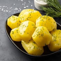 Boiled potatoes drizzled with parsley on a bowl, How To Tell When Potatoes Are Done Boiling