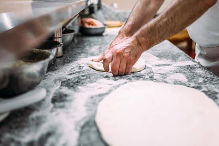 A chef preparing pizza dough, How Long to Knead Pizza Dough