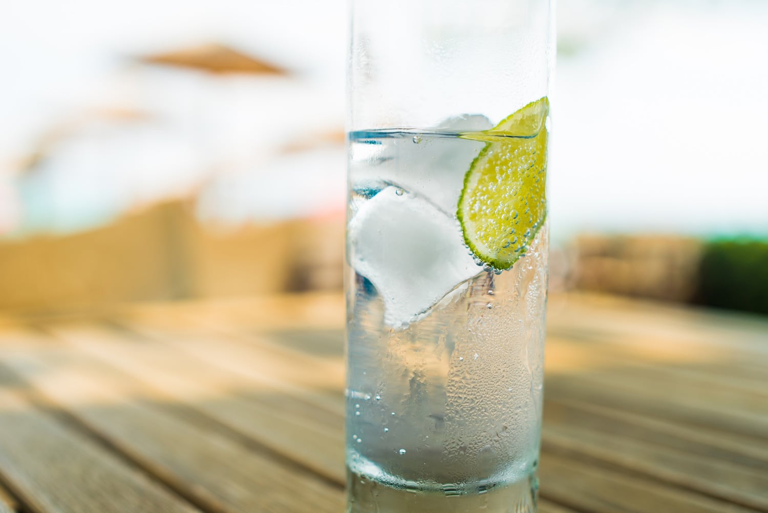 Close up of a refreshing ice cold glass of water with a slice of lime