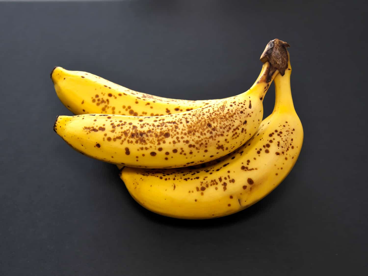  Closeup of ripe bananas on black background