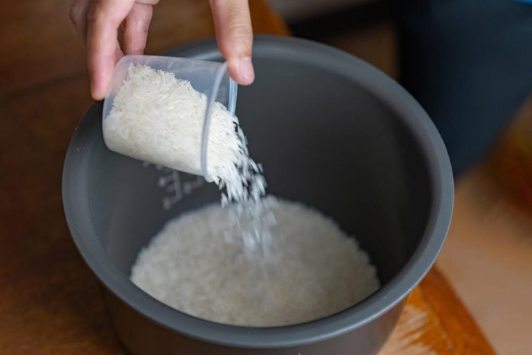 A cook measured the rice with a measuring cup to cook the rice. How Big Is A Rice Cooker Cup?