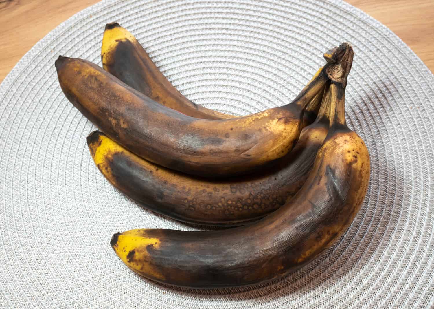 Dark and Spoiled banana on the table. Rotten fruit.