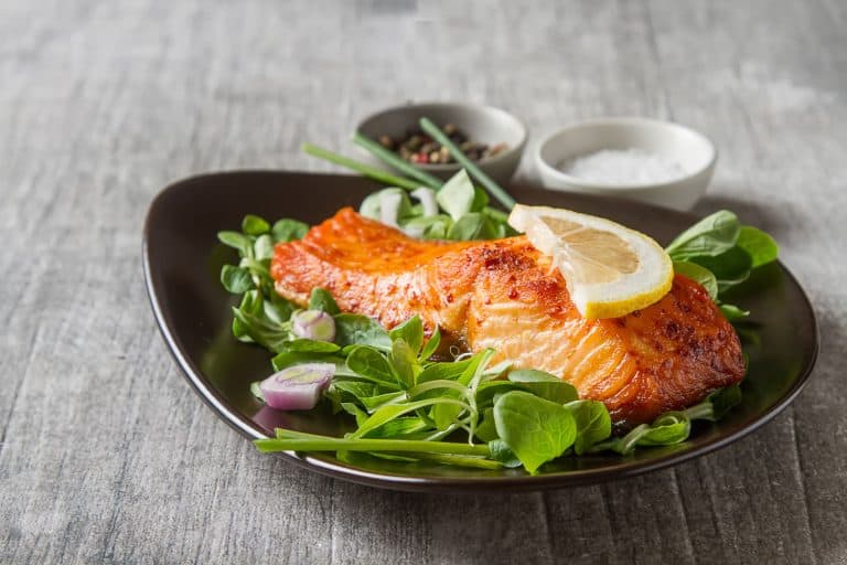 Delicious baked salmon with spinach and onions on the side, Should You Bake Or Broil Salmon?