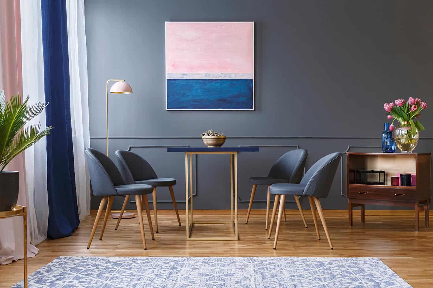 Four chairs standing around a table in a spacious dining room