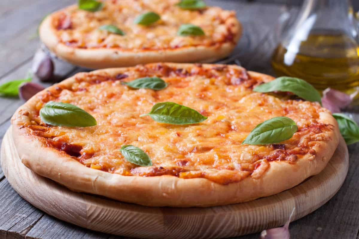 Freshly baked pizza garnished with parsley leaves