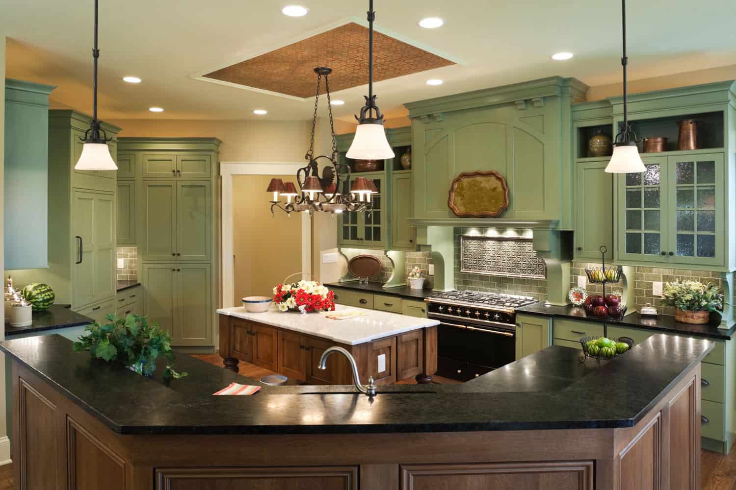 Green Kitchen Cabinet with black staineless appliances