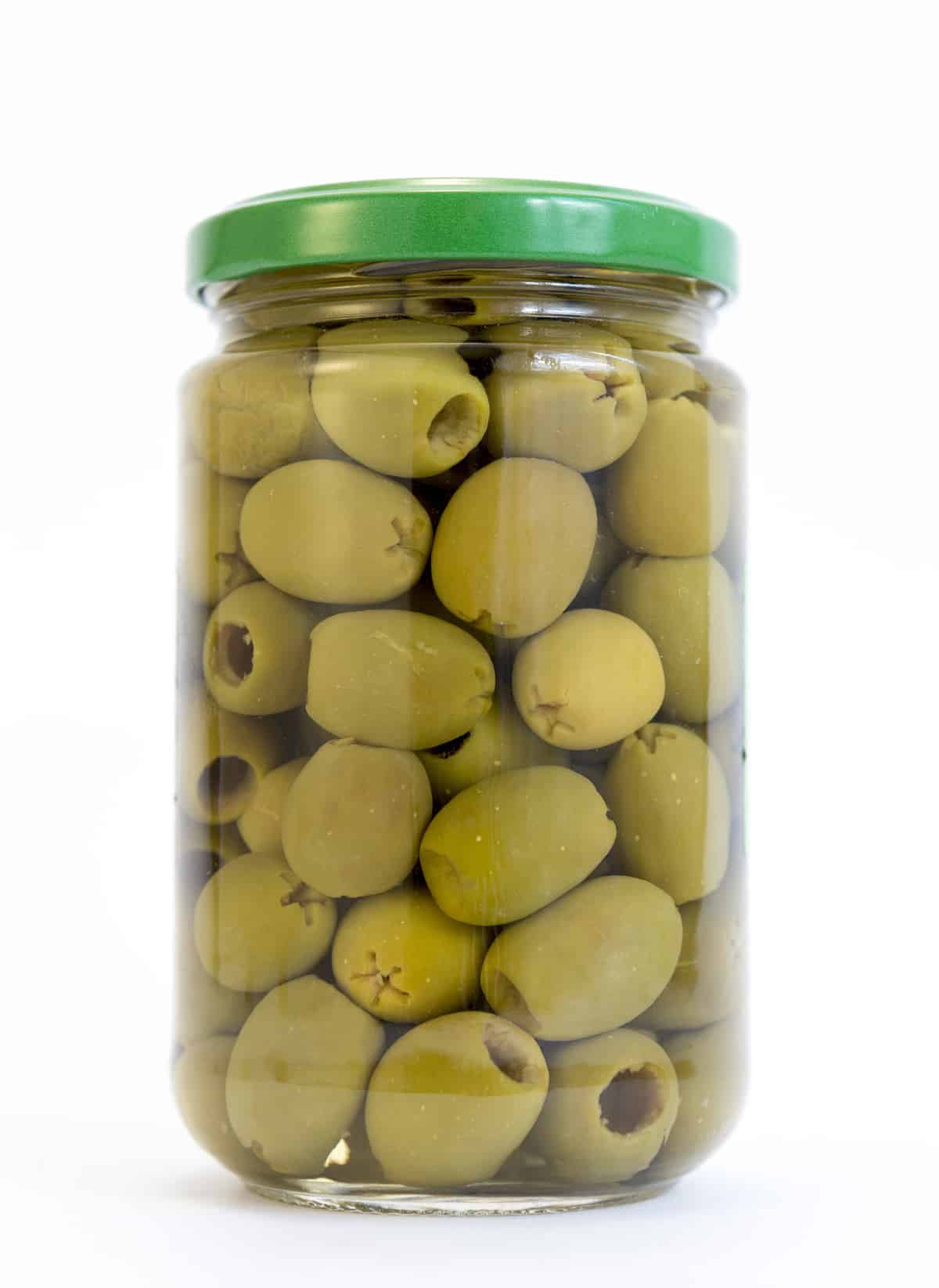 Green olives in a jar isolated on white.