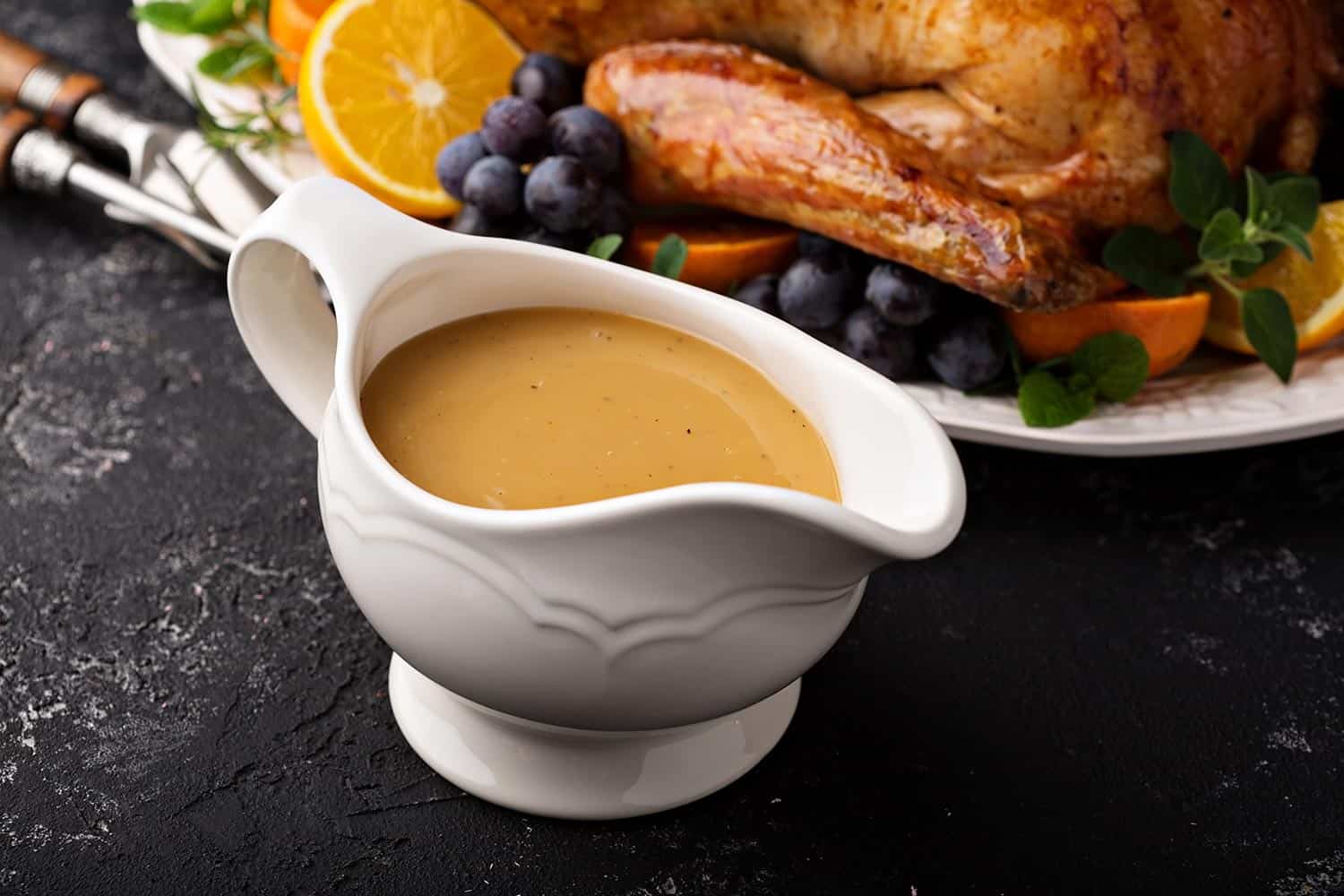Homemade gravy in a sauce dish with turkey for Thanksgiving