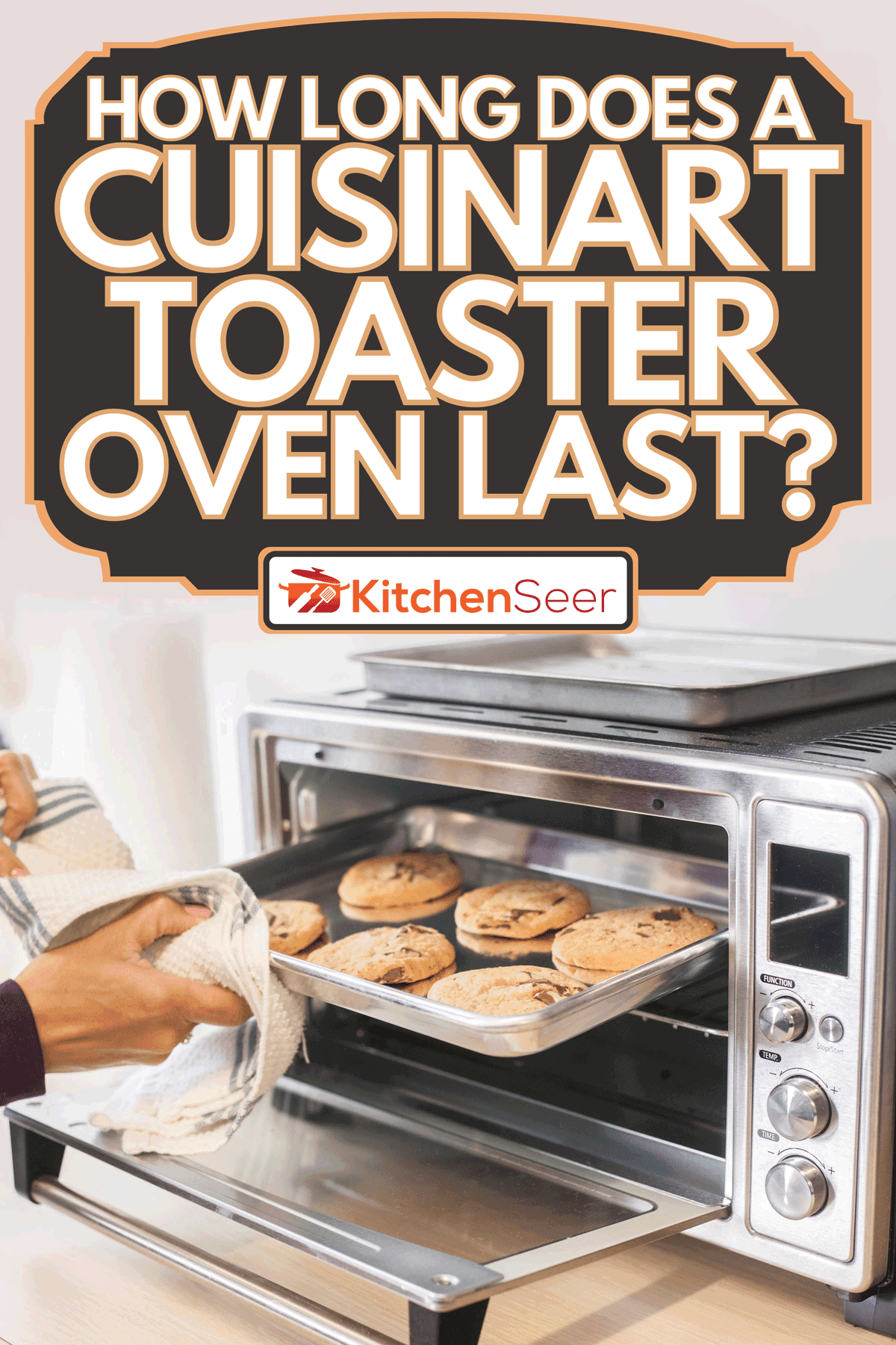 Female using a towel to remove a small baking sheet full of chocolate chip cookies from a silver toaster oven, How Long Does A Cuisinart Toaster Oven Last?