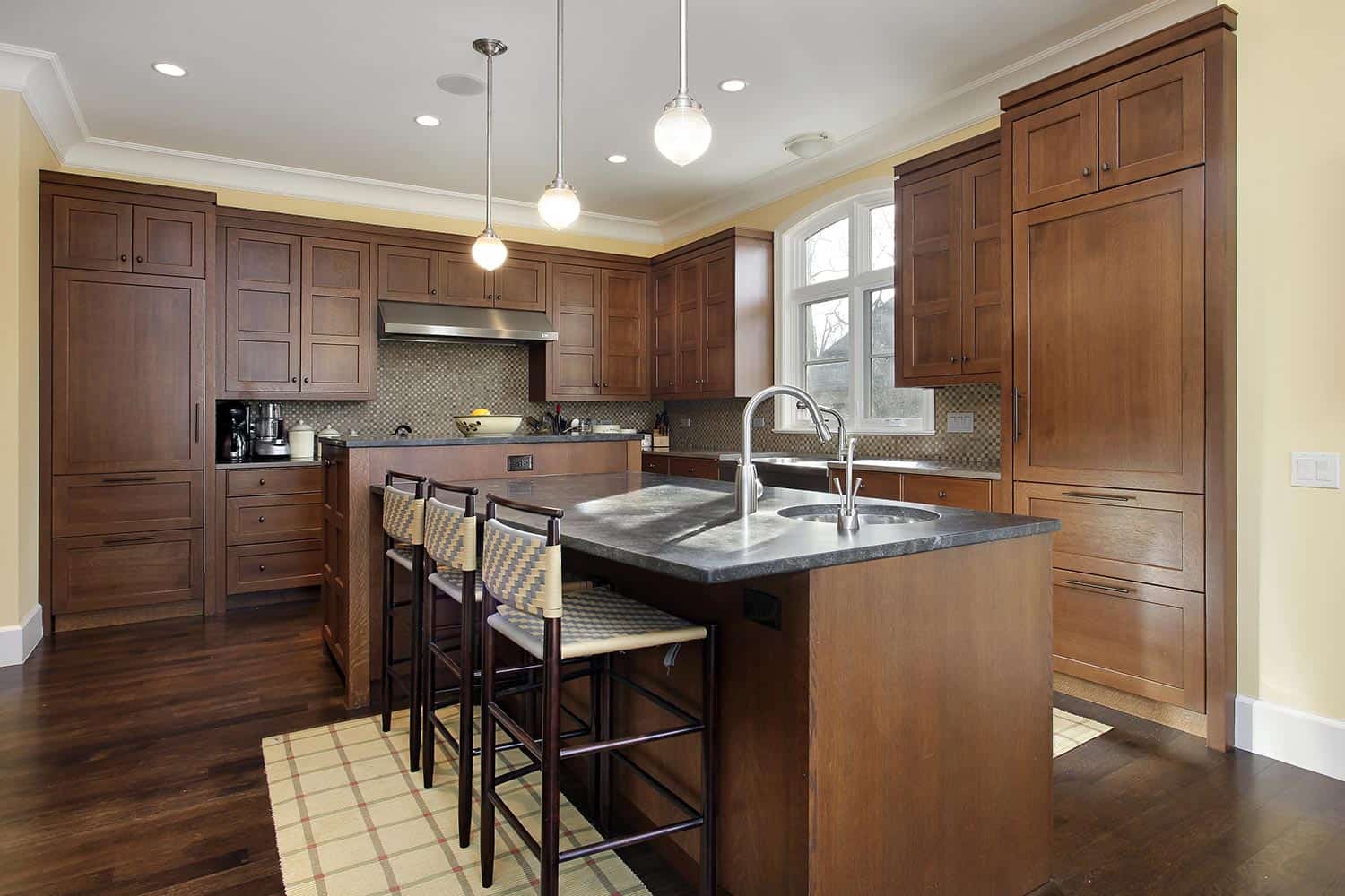 Kitchen in luxury home with oak wood cabinetry